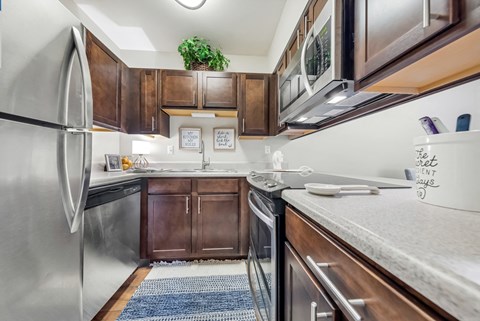 a kitchen with stainless steel appliances and wooden cabinets